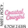 Detail view of pink and white Coastal Cowgirl embroidered patch showing 6.7x4.3cm dimensions - No.6 (Coastal Cowgirl Text)