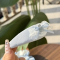 Close-up of light blue fabric hair clip with white lace, silk bow and cute cat charm - Grey Cat Lace Bow Dusty Blue BB Clip