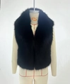 Close-up of the plush black faux fur texture and wide lapel collar on the fashion vest - Black
