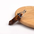 Tiger eye crystal hexagonal prism pendant with silver clasp on wooden base - Resin Tigers Eye