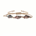 Detail of hand-woven shell bracelet with reddish-brown spotted shells and pearl accents - Light Cyan
