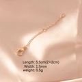 Detail view of rose gold extension chain with lobster clasp on soft silk fabric - Rose Gold Plated 2 Segments