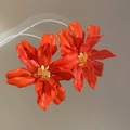 Macro shot of large vibrant red acrylic flower earrings with yellow beaded centers - Silver Needle (Orange) / Orange