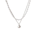 Detail of double-layer necklace featuring a pearl strand and a single pearl pendant - Silver Pearl Necklace