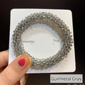 Elastic beaded hair tie in gunmetal grey finish displayed on a daily label card - Gunmetal Grey Crystal