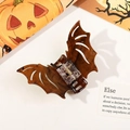 Macro detail of bat-shaped hair claw clip with tortoiseshell texture for Halloween styling - Tortoise Bat-Brown