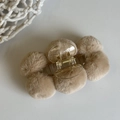 Detail of light brown plush ball hair claw clip with a transparent spring base - Apricot