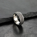 8mm silver spinner ring in stainless steel with industrial mesh texture on rock background - US 10 / Steel