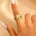 Golden wide band ring featuring a heart-shaped zircon and flower details on model's hand - Heart Zircon 3D Decorated Wide Style (A-754)