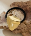 Detail showing high-elasticity black hair tie with irregular gold metal decoration - Irregular Triangle