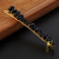 Close-up of golden hair clip with blue natural stone chips and wire-wrapped detail - Blue Goldstone + Gold Clip