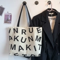 Minimalist beige canvas tote bag with black letter print and black shoulder strap - KUNM Black Letters