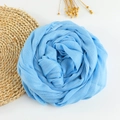 Bright blue cotton linen scarf with frayed edges folded into a rose shape - 190x100cm / Light Blue