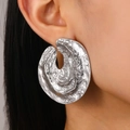Chunky silver irregular textured alloy stud earrings worn by a model in vintage style - Silver