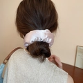 Pink satin polka dot scrunchie with lace trim shown on a stylish bun hairstyle - Light Pink Satin (40#)