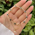 Detailed macro view of 18K gold plated bracelet with heart-shaped blue stones and zircon stones - Dark Blue