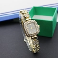 Close-up of a luxury gold square watch with crystal-encrusted bezel on a stand - Square Gold Black