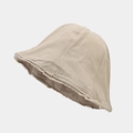 Detailed view of beige bucket hat featuring raw frayed edges and textured cotton fabric - One Size / Khaki
