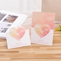 Biglietti d'auguri cuore 3D rosa e bianco con citazione 'love love' su tavolo in legno - Love Love / Arancione Chiaro