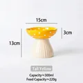 Polished ceramic mushroom-shaped elevated pet bowl in bright yellow with white polka dots - Elevated Yellow Mushroom Bowl
