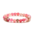 Rosa Perlenarmband mit Farbverlauf, Roségold-Kronen und einer kristallbesetzten Kugel - Linienachat