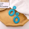 Bohemian style sky blue woven oval double hoop earrings on a beige stone tray - Sky Blue Woven Geometric Double Hoop