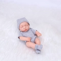 Realistic 20cm reborn baby doll in grey striped onesie sleeping on white plush rug - Grey Striped Style