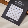 Macro detail of square pearl nail art studs with silver metal frames in black packaging - MJ-012 Silver Border