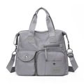 Detail of grey Oxford travel bag showing multi-pocket design and adjustable shoulder strap - Gray