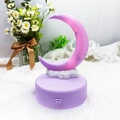 Detailed close-up of a purple crescent moon night light with heart button and cloud base - Purple