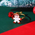 Detail of gold open ring with gingerbread man pendant and red bell on festive background - Gingerbread Man Red Bell Ring (5717)