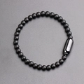 Men's matte black beaded bracelet with sleek stainless steel capsule clasp on grey texture - Matte Beaded Capsule Clasp / Black