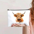 Detail of canvas makeup bag with watercolor highland cow print held by hand - Watercolor Art Highland Cow (140-3)