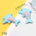 Macro detail of blue resin dolphin charms showing 1.8cm x 2.8cm dimensions and 2.0g weight - Blue Dolphin