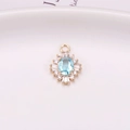 Luxurious light blue oval gemstone pendant with gold plating and white cubic zirconia - Lake Blue