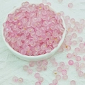 Macro detail of 6mm frosted pink glass beads with gold foil inside for DIY jewelry - 6mm Pink with Gold Glitter