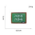 Macro detail of blackboard embroidery patch with chalk formulas measuring 6.8x5cm - Blackboard