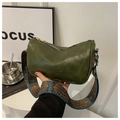 Detailed view of a green soft faux leather crossbody bag with a colorful pattern strap - Green