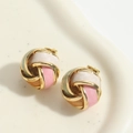 Macro shot of colorful enamel vortex knot earrings with polished gold metallic frame - White Pink