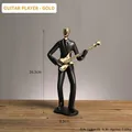 Scultura moderna minimalista di un chitarrista nero e oro con dettagli dimensionali - Chitarrista (Oro)