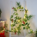 Christmas pine garland with red berries and warm LED lights on a white decorative ladder - Garland Without Light
