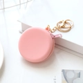 Pink round silicone mini coin purse with a gold keychain and zipper closure - Pink