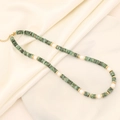 Close-up of green natural stone and pearl necklace on beige silk and white plate - 8# African Pine Emperor Stone