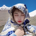 Beige sun protection shawl with blue ethnic patterns shown in a scenic mountain landscape - Blue Elephant Pattern