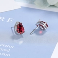 Detailed view of teardrop red zircon earrings with silver metal prong setting - Red Zirconia