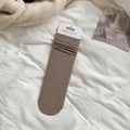 Brown slouch socks for women in ribbed cotton finish with minimalist paper packaging - Light Coffee
