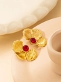 Detail of vintage gold leaf stud earrings with centered red zircon gemstone inlay - Red Petal