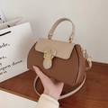 Detail of lychee pattern leather contrast color handbag with gold circular clasp closure - Brown