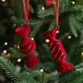 Red flocked Christmas candy ornaments with gold glitter stripes on a festive tree - Red Flocked Candy Set (2Pcs)