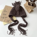 Dark coffee chunky knit beanie with braided ear flaps and tassels on white background - Dark Coffee